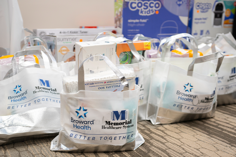 Memorial Healthcare System and Broward Health branded gift bags at 2026 Maternal Health Baby Shower