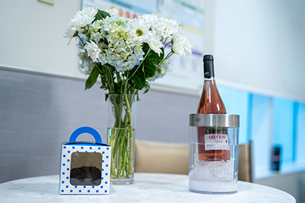 Table with flowers and treats in maternity room