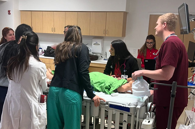 Emergency medicine residents going over a critical patient exercise at the emergency department