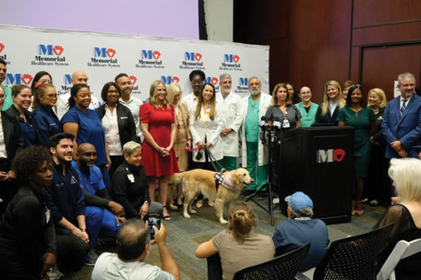 Priscilla with Memorial's ICU team, and pet therapy dogs, Scrunchie and Honey-crisp at reunion