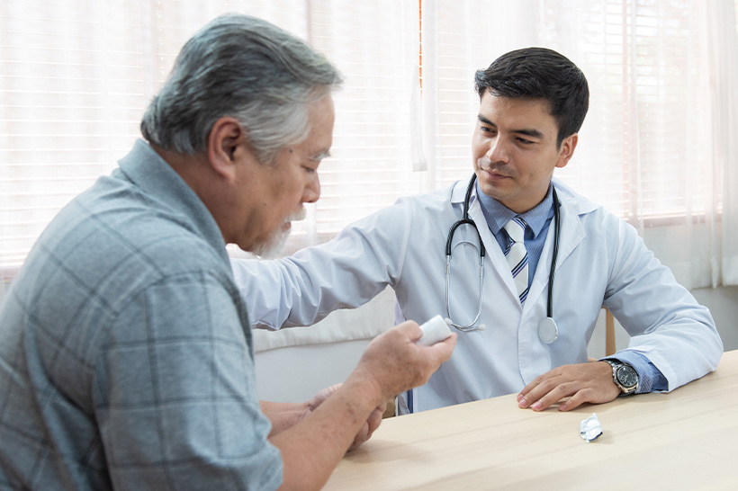A doctor speaks with an older man